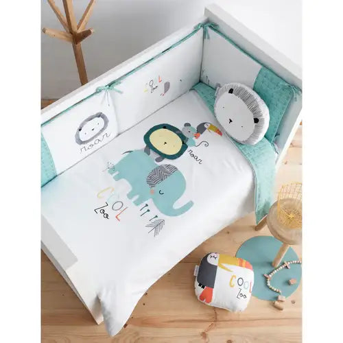 Children's crib bedding set with cute animal prints, including elephant and lion, in a nursery.
